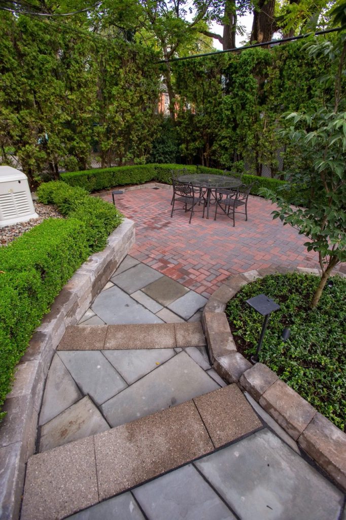 A custom brick paver patio featured in our landscape design portfolio.