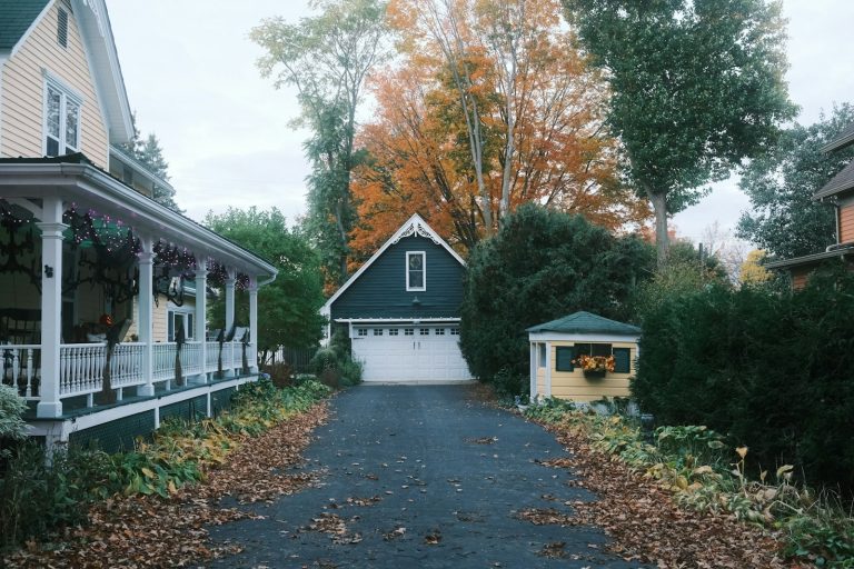 Michigan home landscape with colorful autumn trees and a clean lawn prepared for fall