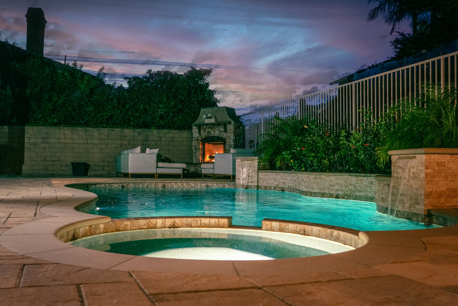 Landscape lighting illuminating a finished backyard at night