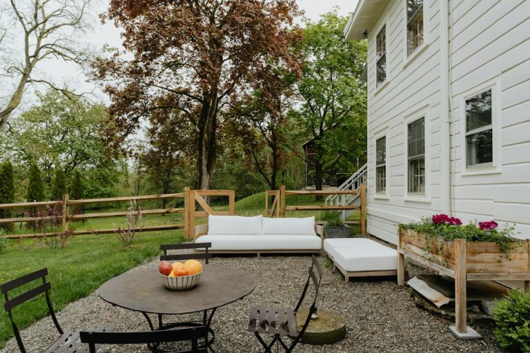 Backyard patio with surrounding planting beds showing hardscape and softscape balance
