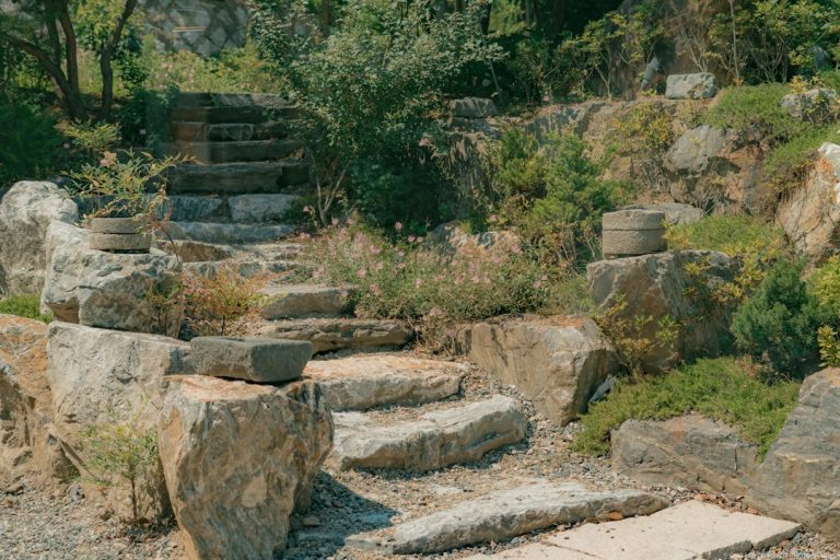 Stone steps and retaining wall in a landscaped sloped garden area